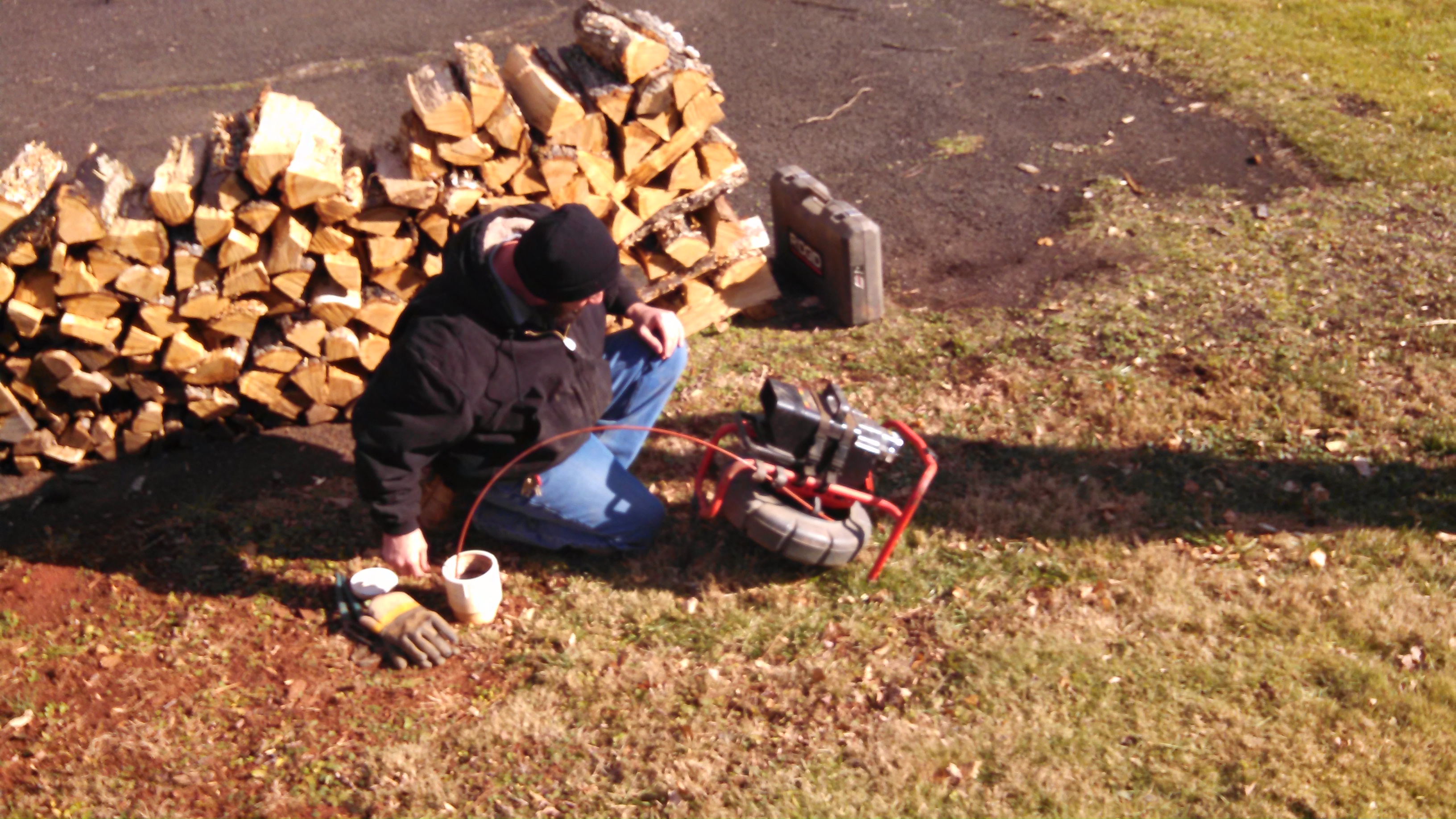Inserting the probe/camera into the septic line.